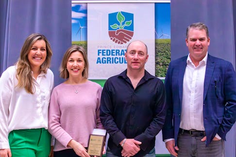 Keisha Rose Topic, left, president of the P.E.I. Federation of Agriculture, joins Agriculture Minister Bloyce Thompson, right, to present Heather and Gordon McKenna of Bunny Burrow Vegetable Co. with the Hon. Gilbert Clements Award for 2023. Jillian Ferguson • Special to SaltWire