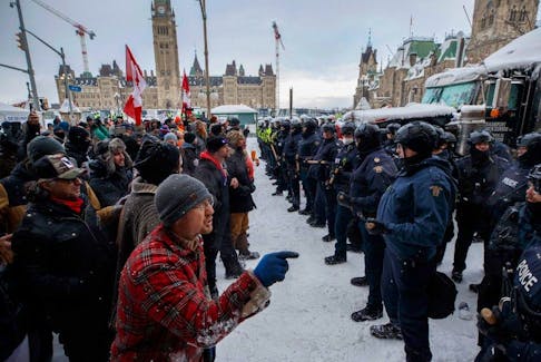 Police move in to clear downtown Ottawa near Parliament hill of protesters after weeks of demonstrations on Feb. 19, 2022.