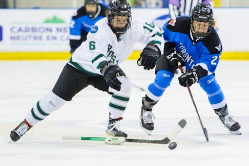 Despite beging without a stick, Boston’s Amanda Pelkey (left) tries to keep Toronto’s Emma Maltais away from the puck during a PWHL game in Toronto on March 20, 2024.