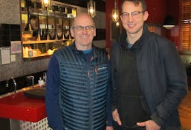 Ken Poole, left, and restaurant owner Logan Campbell are shown recently at Reds Diner in Calgary. Poole was the first badminton player from Nova Scotia to ever win a national championship in the sport. Contributed