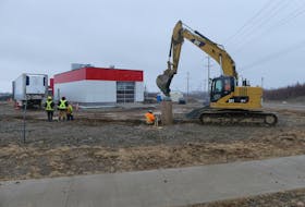 An excavator digs a signpost hole behind the site of a future car wash facility in Membertou's Seventh Exchange retail district. Mitchell Ferguson/Cape Breton Post