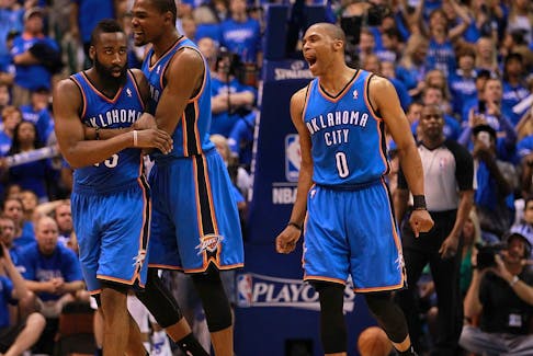 James Harden #13, Kevin Durant #35 and Russell Westbrook #0 of the Oklahoma City Thunder celebrate after scoring with 10 seconds against the Dallas Mavericks during Game Four of the Western Conference Quarterfinals in the 2012 NBA Playoffs at American Airlines Center on May 5, 2012 in Dallas, Texas. 