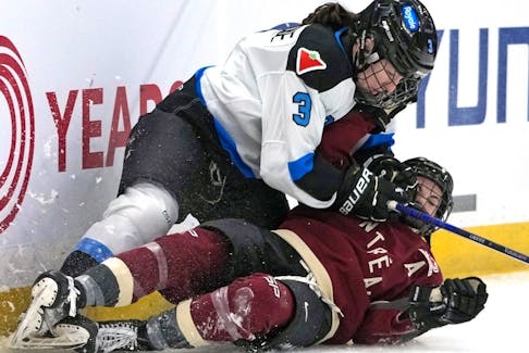 Toronto's Jocelyne Larocque (3) slides into the boards with Montreal's Kristin O'Neill during the second period of a PWHL game in Pittsburgh, Sunday, March 17, 2024. 