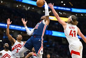 Washington Wizards forward Richaun Holmes, second from right, grabs a rebound against Toronto Raptors forward Kelly Olynyk (41) and Toronto Raptors guard Jahmi'us Ramsey, second from left on Saturday night. 
