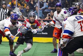 Dan Lintner of the Toronto Rock breaks free from the checking of the Halifax Thunderbirds' Nonkon Thompson and stares down goalkeeper Warren Hill during a National Lacrosse League game Saturday night in Hamilton, Ont. - NATIONAL LACROSSE LEAGUE