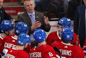 Montreal Canadiens coach Martin St. Louis talks to his players during a timeout during third-period NHL action against the Arizona Coyotes in Montreal on Tuesday Feb. 27, 2024.