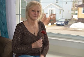 Joanne Frost sits in the living room of her Sydney home earlier this month holding a metal rose her son Nicholas Frenette made for her during a class at Nova Scotia Community College in Sydney where he studied metal fabrication. It is a prized possession of Frost, who lost Frenette when he was 22 after a short battle with an aggressive cancer. NICOLE SULLIVAN/CAPE BRETON POST