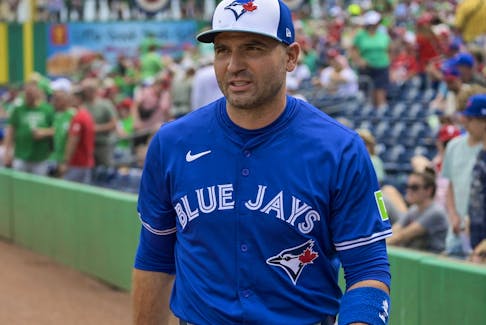 Toronto Blue Jays’ Joey Votto walks on the field during a spring training game.