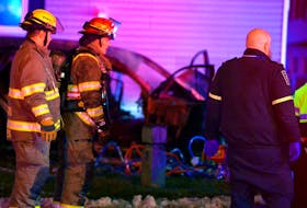 One person is dead and another is in critical condition following a fiery single vehicle crash in St. John’s Sunday morning. The incident happened just after 6 a.m. when a westbound SUV went off the road on Empire Avenue at Grave Street. The vehicle then overturned and apparently crashed into a nearby house roof first before coming to rest on the front lawn and bursting into flames. A third occupant of the vehicle was sent to hospital with undetermined injuries. A resident of the house that was struck during the crash and was thrown from his couch during the impact was later sent the hospital with injuries that were not considered serious. The SUV was fully engulfed in fire and burning next to the home when firefighters arrived on scene. They made quick work of the fire, leaving relatively minor fire damage to the home which was already significantly damaged from the crash. Police closed off a section of Empire Avenue between Freshwater Road and Monchy Street so they could investigate the crash. The incident left one of the vehicle's bumpers about forty metres further down the road. More details will be provided as they become available.

Keith Gosse/The Telegram