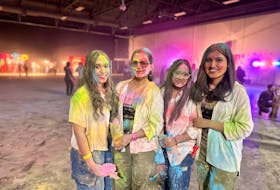 From left, Raman Kaur, Sukhpreet Kaur, Sukhmeen Kaur and Sonali, who live in Charlottetown, pause from dancing and tossing coloured powder for a moment during a Holi festival celebration held at Charlottetown’s Eastlink Centre on March 24. Thinh Nguyen • The Guardian