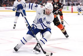 Morgan Rielly of the Toronto Maple Leafs controls the puck against the Anaheim Ducks.