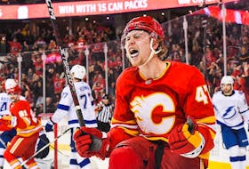 Connor Zary #47 of the Calgary Flames celebrates after scoring against the Tampa Bay Lightning during the third period of an NHL game at the Scotiabank Saddledome on December 16, 2023 in Calgary, Alberta, Canada.