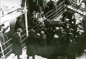 Medical personnel carry survivor Ralph Mouland off the SS Bellaventure, which was used as a rescue ship during the 1914 Newfoundland sealing disaster. - Queen Elizabeth II Library/Wikimedia Commons