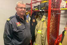 Donald Whalen, president of the International Association of Fire Fighters Local 2779, stands in front of the racks of bunker gear at the Cape Breton Regional Fire Service’s Sydney Fire Station No. 1. He said an extra set of bunker gear would reduce the cancer risk for firefighters. Chris Connors/Cape Breton Post