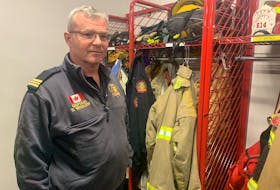 Donald Whalen, president of the International Association of Fire Fighters Local 2779, stands in front of the racks of bunker gear at the Cape Breton Regional Fire Service’s Sydney Fire Station No. 1. He said an extra set of bunker gear would reduce the cancer risk for firefighters. Chris Connors/Cape Breton Post