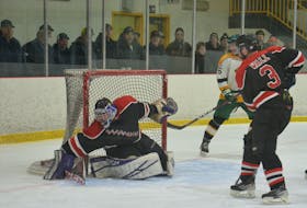 Kensington Granites goaltender Tyler Caseley freezes the puck during second-period action in Game 4 of the best-of-seven Lone Oak West Prince Senior Hockey League championship series against the Tignish Aces on March 25 as Granites defenceman Dylan Wall, 3, and Aces forward TJ Shea, 6, watch for a rebound. The Granites won the game 5-4 to cut Tignish’s series lead to 3-1. Game 5 is in Kensington on March 29 at 7:30 p.m. Jason Simmonds • The Guardian
