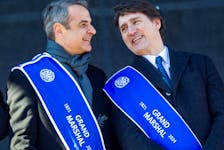 Prime Minister Justin Trudeau  and Greek Prime Minister Kyriakos Mitsotakis on the reviewing stand during the 2024 Greek Independence Day Parade in Montreal on Sunday.