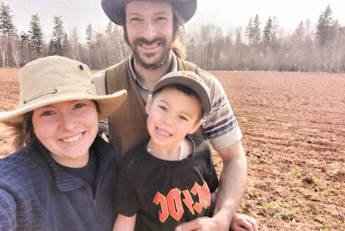 Dakota Oliver, left, her partner James Strongman, and their son, Tucker strongman, stand in their field. In 2023, the Alberton couple started a farm, Strongman's Hand-Picked Produce, and are now paying it forward through creating a Facebook group dedicated to sharing fresh vegetables. – Contributed