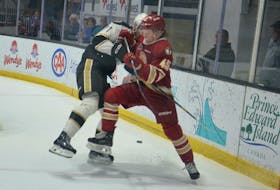 Acadie-Bathurst Titan defenceman Harry Clements of High Bank, P.E.I., battles with the Charlottetown Islanders’ Ondrej Maruna, 71, during a recent Quebec Maritimes Junior Hockey League game at Eastlink Centre. Clements is in his second season with the Titan. Jason Simmonds • The Guardian