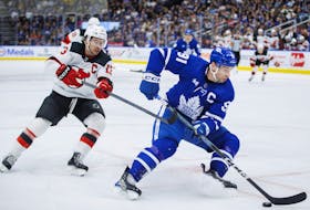 Toronto Maple Leafs centre John Tavares (91) skates the puck by New Jersey Devils centre Nico Hischier.