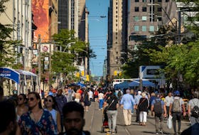 People walk along King Street West at the Toronto International Film Festival (TIFF) in Toronto, Ontario, Canada September 8, 2022.