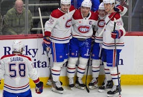 Canadiens defenceman David Savard heads over to congratulate centre Nick Suzuki, second from left, after his goal against the Avalanche Tuesday night in Colorado. Congratulating Suzuki are, from left, defenceman Arber Xhekaj, wingers Cole Caufield and Juraj Slafkovsky.