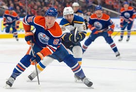 Dylan Holloway (55)of the Edmonton Oilers, skates away from Jordan Kyrou(25) of the St. Louis Blues at Rogers Place in Edmonton on Feb. 28, 2024 Photo by Shaughn Butts-Postmedia
