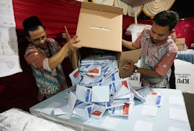 Electoral officers count votes at a polling station after general election polls closed in Jakarta, Indonesia February 14, 2024.