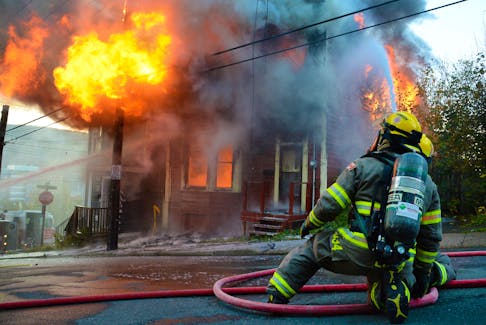 Up in flames

A firefighter from St. John's Regional Fire Department steadies a hose onto a home on Lime Street engulfed in fire Monday morning, Oct. 30. See more photos and story on Page 4. Keith Gosse/The Telegram