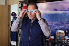 Niagara Falls, Ontario Mayor Jim Diodati, who says the city is preparing to host more than one million visitors during the upcoming April 8 solar eclipse event, poses with a pair of safety glasses at his office in Niagara Falls, Ontario, Canada March 22, 2024. 