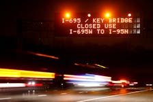 Highway signs direct drivers to a detour for Francis Scott Key Bridge following the bridge's collapse, in Baltimore, Maryland, U.S., March 26, 2024.