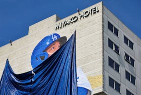 A giant mural of Shohei Ohtani is covered before its unveiling on the side of a hotel in Little Tokyo, a neighborhood in downtown Los Angeles, ahead of Shohei Ohtani's opening game and season with his new team the Los Angeles Dodgers in Los Angeles, California, U.S. March 27, 2024.