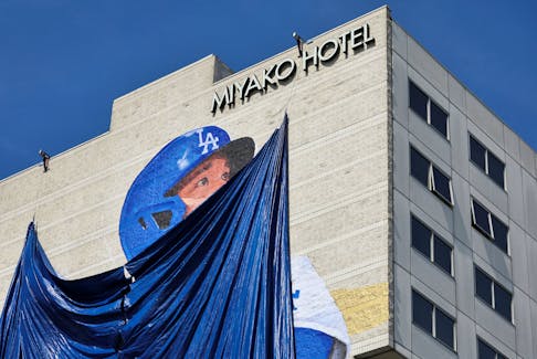 A giant mural of Shohei Ohtani is covered before its unveiling on the side of a hotel in Little Tokyo, a neighborhood in downtown Los Angeles, ahead of Shohei Ohtani's opening game and season with his new team the Los Angeles Dodgers in Los Angeles, California, U.S. March 27, 2024.