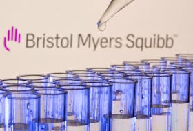 Test tubes are seen in front of a displayed Bristol Myers Squibb logo in this illustration taken, May 21, 2021.