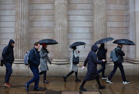 Commuters walk during the morning rush hour near the Bank of England in the City of London financial district in London, Britain, February 8, 2024.