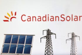Miniatures of solar panel and electric pole are seen in front of Canadian Solar logo in this illustration taken January 17, 2023.