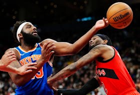 New York Knicks' Mitchell Robinson (left) battles for a rebound with Raptors forward Jalen McDaniels' during the second half in Toronto on Wednesday, March 27, 2024. 