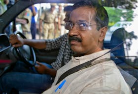 Arvind Kejriwal, the head of the Aam Aadmi (Common Man) Party (AAP), which briefly controlled the state government in Delhi, looks out from inside his car as he arrives at a court in New Delhi May 21, 2014.