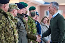 NATO Secretary General Jens Stoltenberg shakes hands with Commander of the Estonian Defence Forces lieutenant general Martin Herem during their visit to NATO enhanced Forward Presence battle group in Tapa military base, Estonia March 1, 2022.