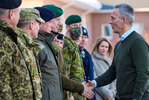 NATO Secretary General Jens Stoltenberg shakes hands with Commander of the Estonian Defence Forces lieutenant general Martin Herem during their visit to NATO enhanced Forward Presence battle group in Tapa military base, Estonia March 1, 2022.