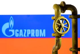 A 3D printed natural gas pipeline is placed in front of displayed Gazprom logo and Russian flag in this illustration taken February 8, 2022.
