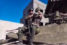 An Israeli soldier sits on top of a tank holding a female mannequin dressed in a black bra and military helmet, in a screengrab of a video obtained by Reuters, released on February 26, 2024, said to be filmed in Khan Younis, Gaza. REUTERS