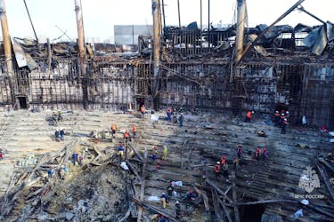Members of the Russian Emergencies Ministry and workers remove debris inside the burnt-out Crocus City Hall following a deadly attack on the concert venue outside Moscow, Russia, in this still image taken from video released March 26, 2024. Russian Emergencies Ministry/Handout via