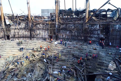 Members of the Russian Emergencies Ministry and workers remove debris inside the burnt-out Crocus City Hall following a deadly attack on the concert venue outside Moscow, Russia, in this still image taken from video released March 26, 2024. Russian Emergencies Ministry/Handout via