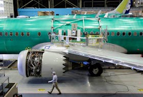 A worker walks past Boeing's new 737 MAX-9 under construction at their production facility in Renton, Washington, U.S., February 13, 2017.