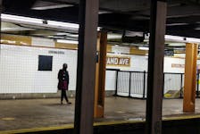 A woman waits for a subway to arrive at the Nostrand Avenue station subway platform in the Brooklyn borough of New York City, U.S., March 12, 2024.