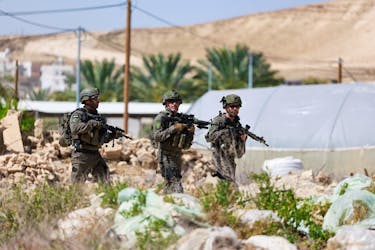 Members of the Israeli army check around the scene of a shooting incident, near Jericho in the Israeli-occupied West Bank, March 28, 2024.