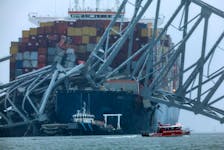 A Marine Emergency Team boat boat passes the wreckage of the Dali cargo vessel, which crashed into the Francis Scott Key Bridge causing it to collapse, in Baltimore, Maryland, U.S., March 27, 2024.