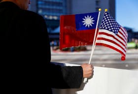 A demonstrator holds flags of Taiwan and the United States in support of Taiwanese President Tsai Ing-wen during an stop-over after her visit to Latin America in Burlingame, California, U.S., January 14, 2017.
