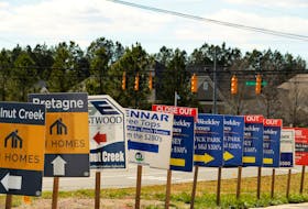 Real estate signs advertise new homes for sale in multiple new developments in York County, South Carolina, U.S., February 29, 2020. 
